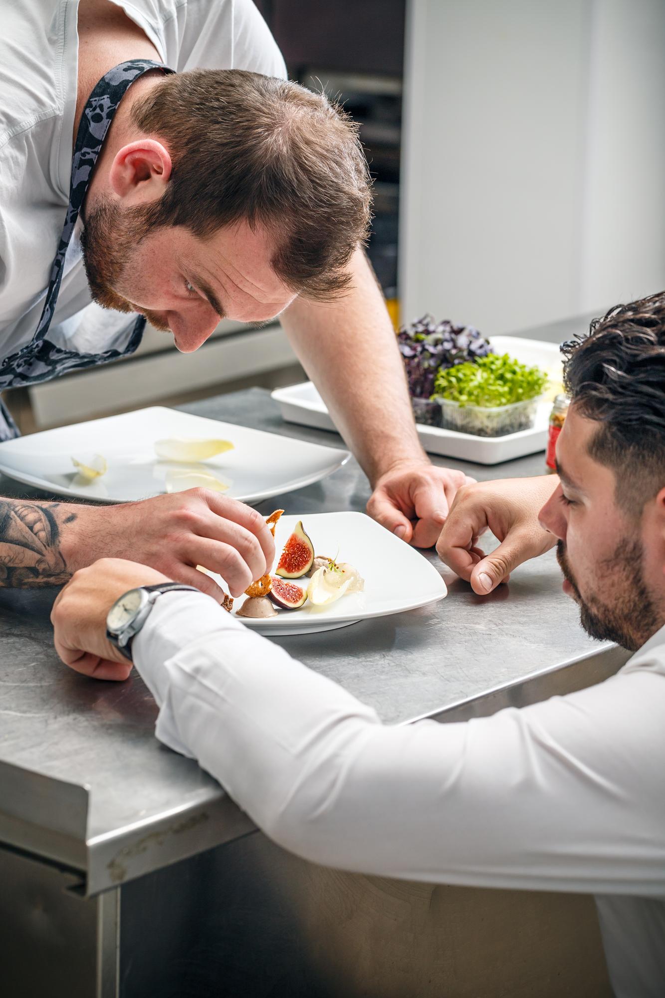 chef consulting with client over plated samples